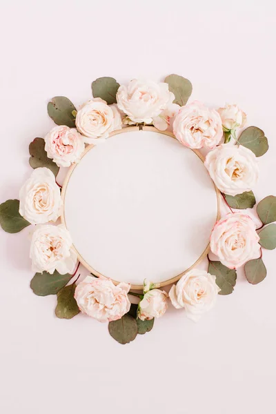 Embroidery frame with beige rose flower buds