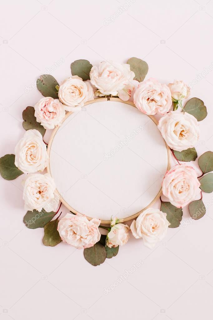 Embroidery frame with beige rose flower buds