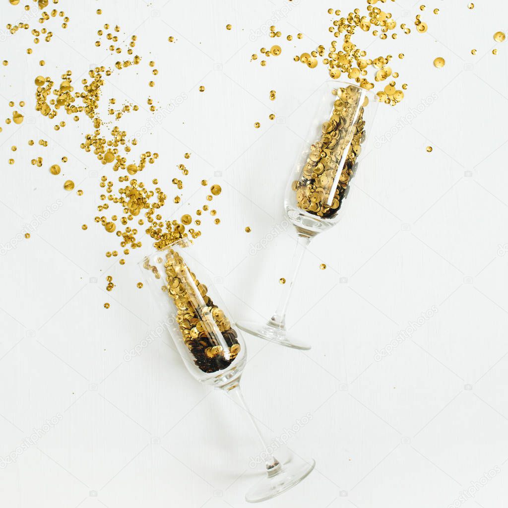 Champagne glasses with golden confetti tinsel