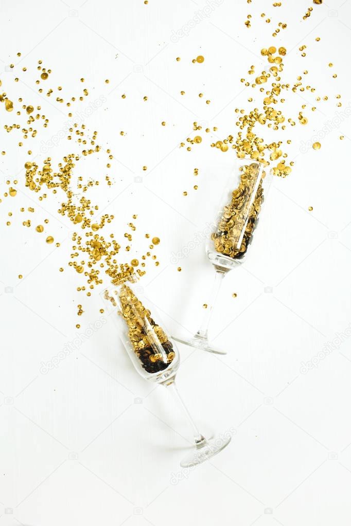 Champagne glasses with golden confetti tinsel