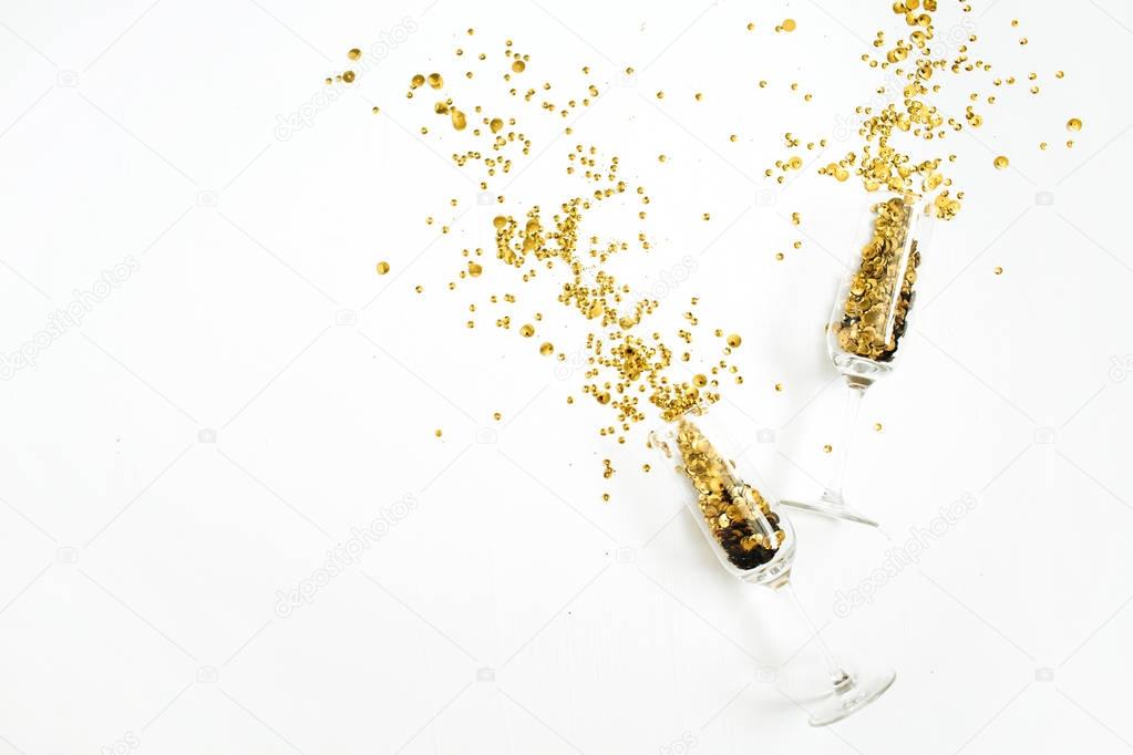 Champagne glasses with golden confetti tinsel