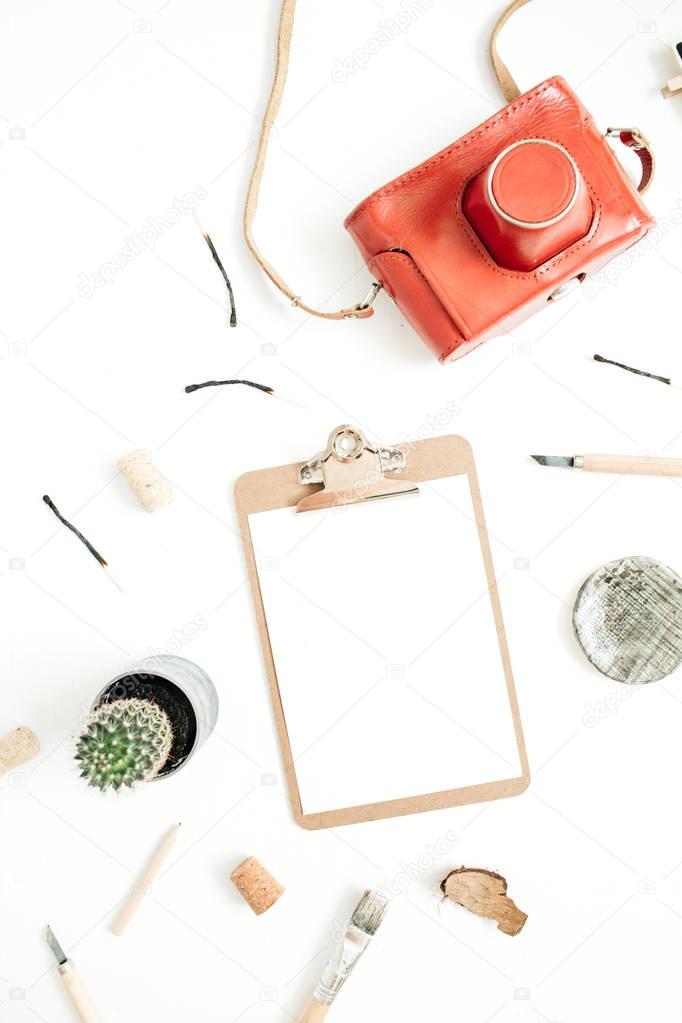 Clipboard with blank paper, retro camera, succulent, tools for handmade arts