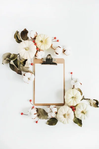 Frame made of white pumpkins, red berries and eucalyptus branches — Stock Photo, Image