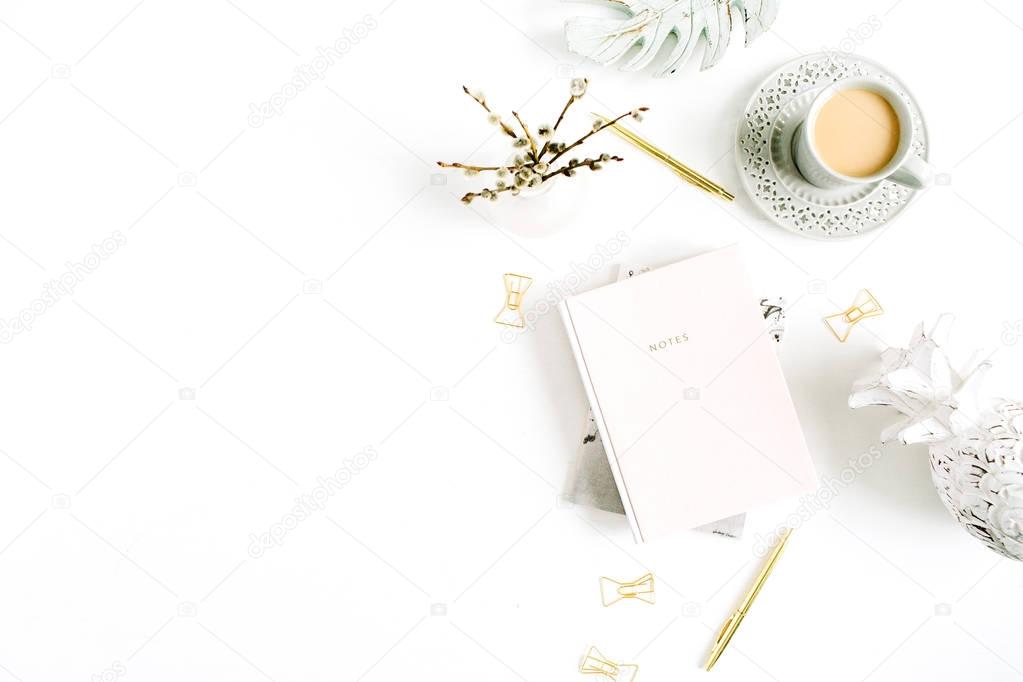 Workspace with pale pastel pink notebook and decorations on white background. Stylish home office desk. Flat lay, top view.
