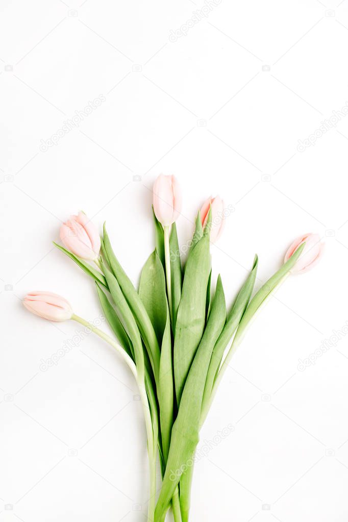 Pastel pink tulip flowers bouquet on white background. Flat lay, top view.