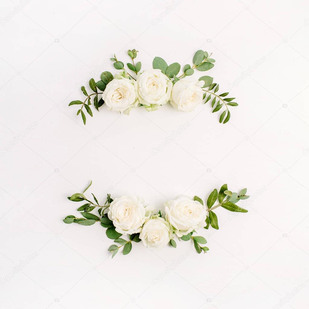 Floral frame wreath of white rose flower buds and eucalyptus on white background. Flat lay, top view mockup.