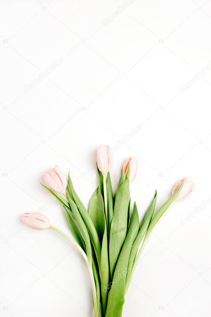 Pastel pink tulip flowers bouquet on white background. Flat lay, top view. Minimal floral concept.