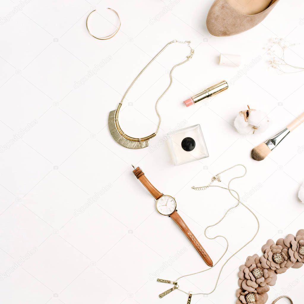 Flat lay fashion composition. Female accessories: shoes, watches, perfume, lipstick, bracelet, necklace with cotton branch on white background. Top view.