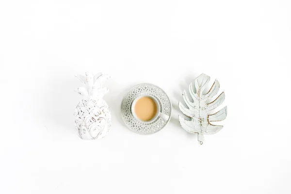 Decorations: pineapple, coffee, monstera palm leaf on white background. Flat lay, top view.