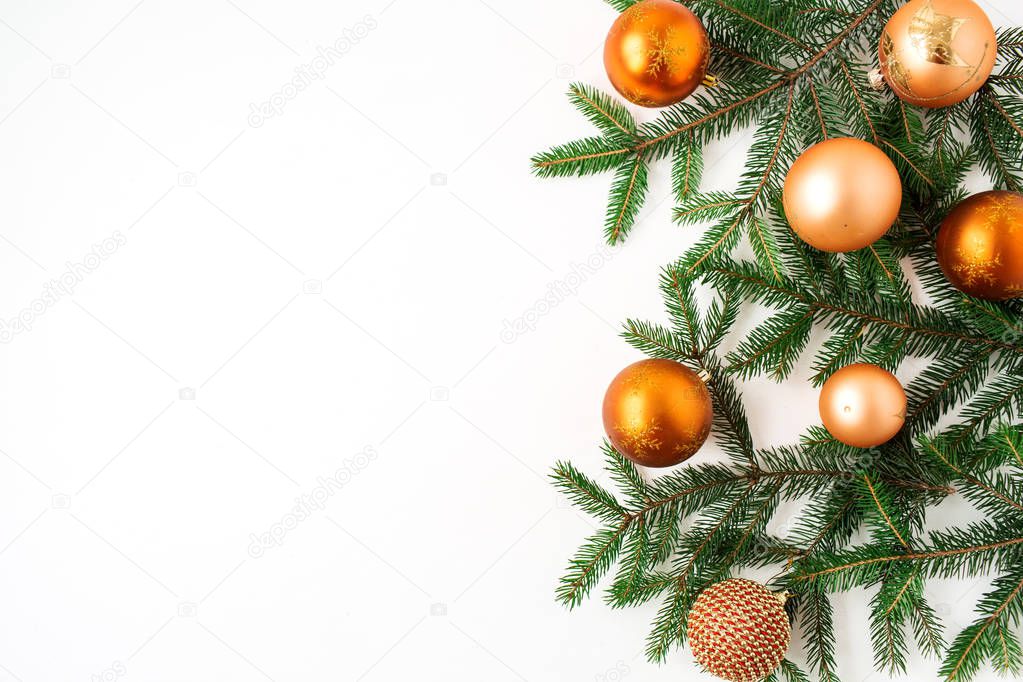 Christmas / New Year holiday composition. Colorful Christmas baubles / balls and fir branches on white background. Flat lay, top view festive concept.