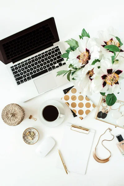 Home office desk table workspace with laptop and flowers on white background. Flat lay, top view freelance work concept.