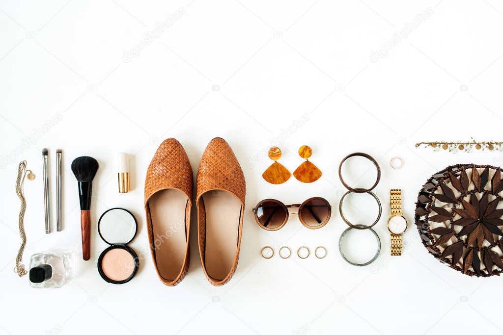 Flat lay fashion collage with women modern bijouterie, cosmetics on white background. Purse bag, shoes, sunglasses, earrings, lipstick, powder. Lifestyle concept for blog, social media, magazine.