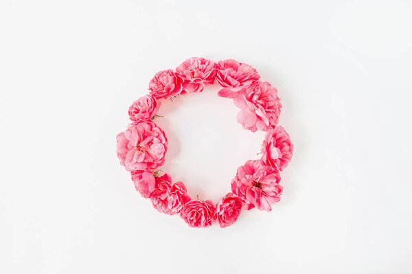 Frame border made of pink rose flowers. Flat lay, top view copy space mockup background.