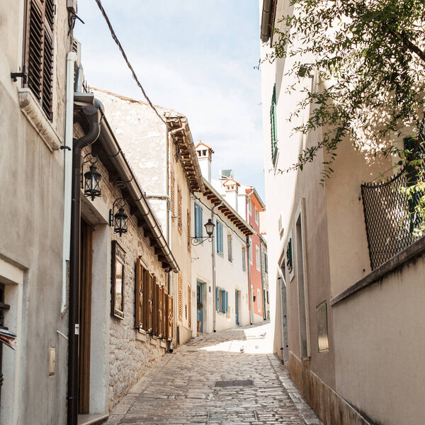 Travel summer concept. Old city view of Europe, Croatia, Istria region, Rovinj. Empty street with old buildings with shutters.  