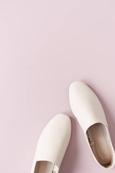 Fashion collage with women's white leather slippers on pink. Minimal flat lay, top view lifestyle concept.