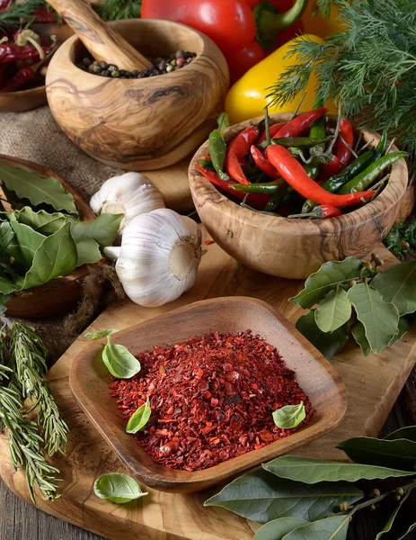 red ground pepper in wooden bowl on cutting board
