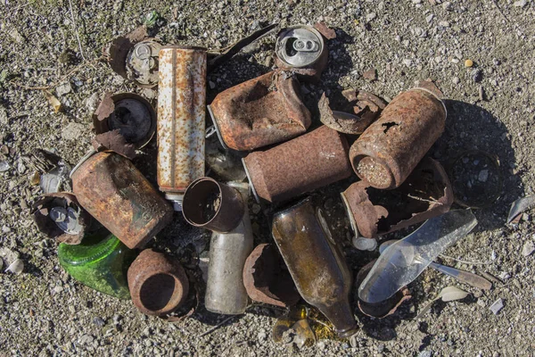 aerial view of rusty cans and glass bottles