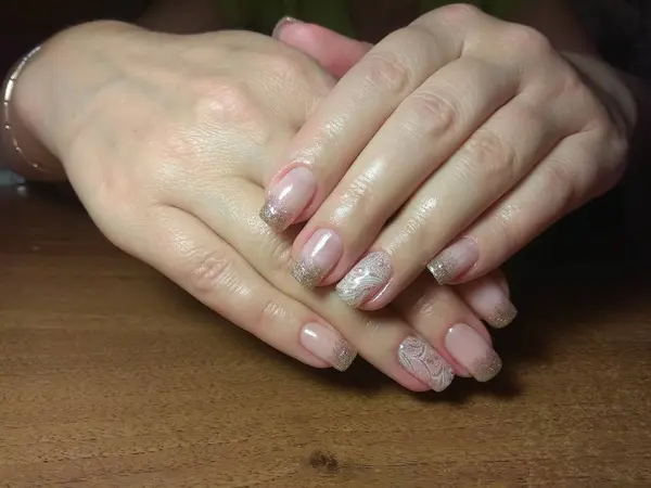 La manicurista hizo excelentemente su trabajo una hermosa manicura con un gel polaco en sus manos y el cliente está feliz —  Fotos de Stock