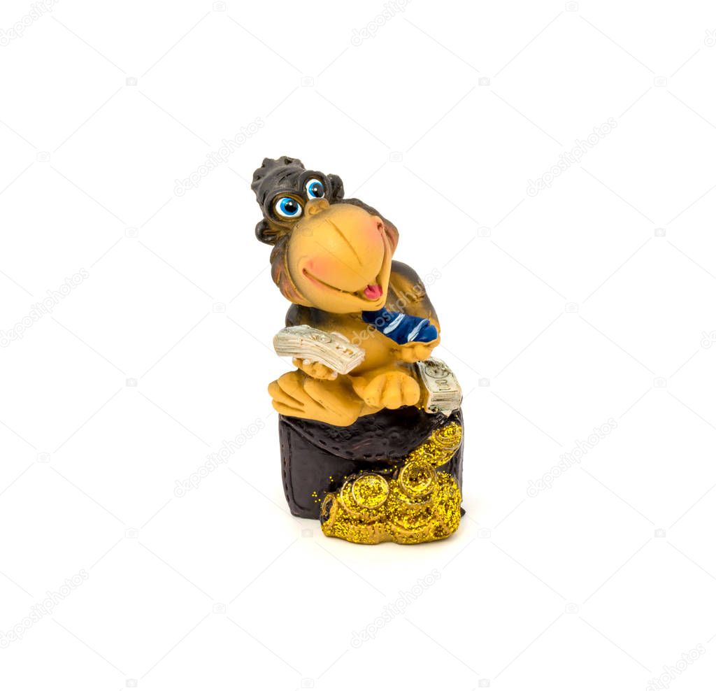 Brown statuette of a monkey with money isolated on a white background