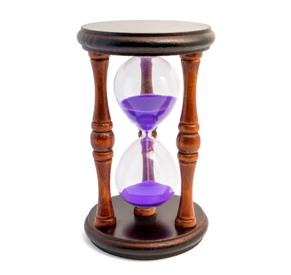 Braune Sanduhr mit violettem Sand isoliert auf weißem Background lizenzfreie Stockfotos