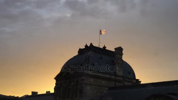 Bandeira da França no topo da ala Sully do Museu do Louvre ao entardecer — Vídeo de Stock