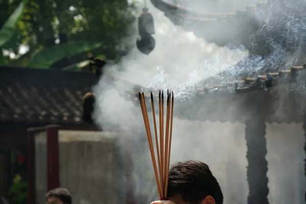 Suzhou,China-September 14, 2019: Joss sticks held by worshippers at Candles at Hanshan Temple in Suzhou, China