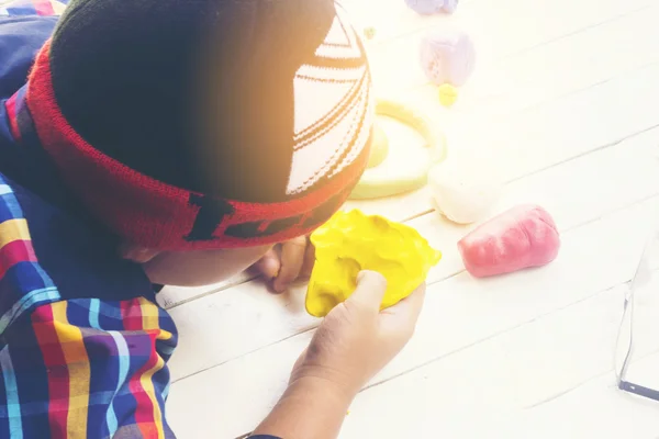 Child with yellow clay and using creativity for making yellow car and etc.Top view and Zoom in. — Stock Photo, Image