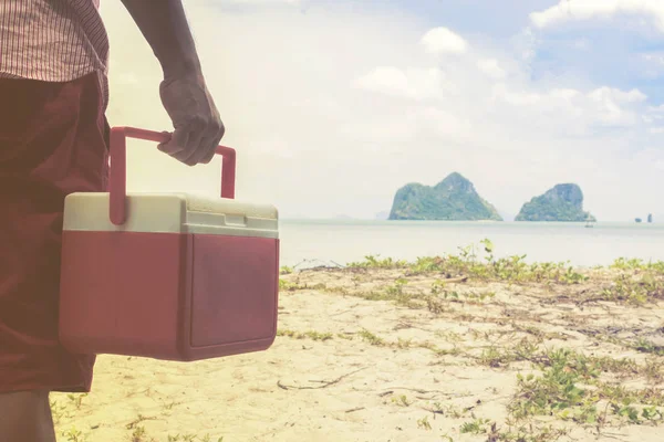 赤い男の手アイス ボックスの背景を持つビーチと島のビュー — ストック写真