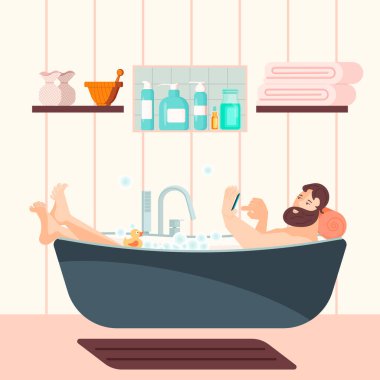 Yakışıklı adam küvette oturuyor.