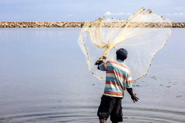 Fisherman throwing a net