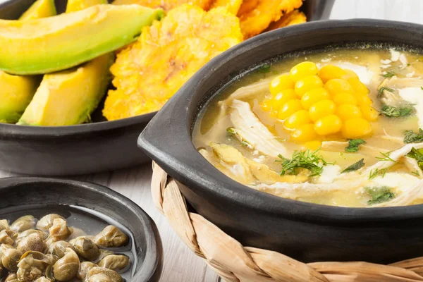 Traditional Colombian ajiaco served on black dish — Stock Image Traditional Colombian ajiaco served on black dish Stock Photo