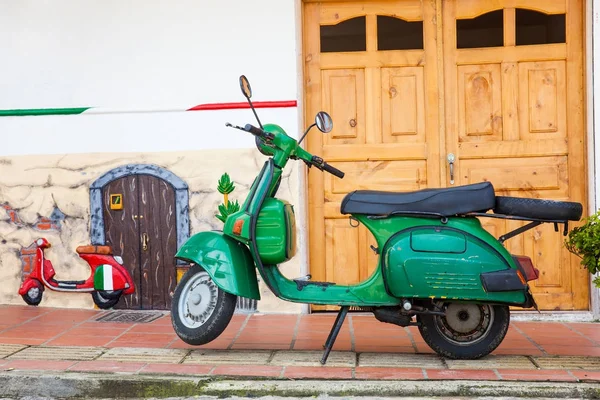 Motocicleta verde na colorida cidade de Guatape, Antioquia Colômbia . — Fotografia de Stock