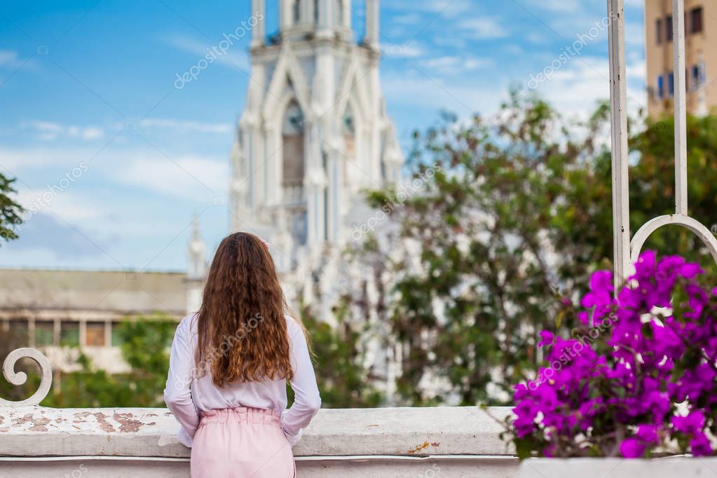 Hermosa joven en el puente de Ortiz mirando la famosa iglesia gótica de La  Ermita construida en 1602 en la ciudad de Cali en Colombia 2023