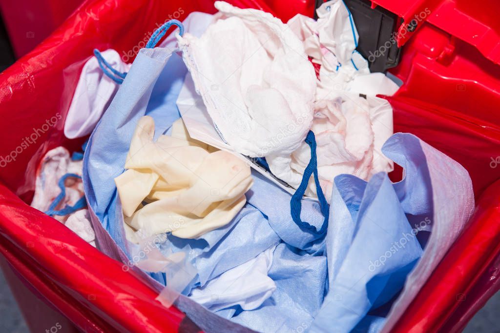 Biological risk waste disposed of in the red trash bag at a operating room in a hospital