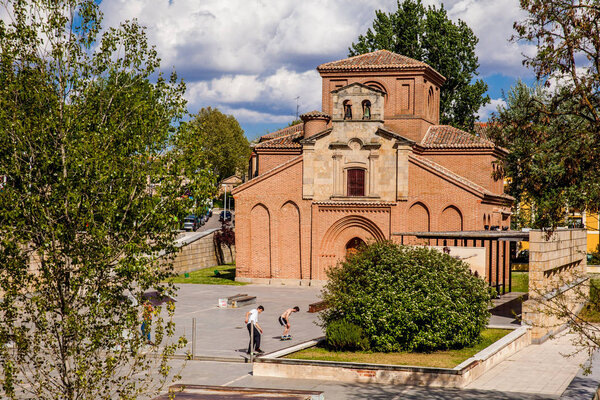 SALAMANCA, SPAIN - MAY, 2018: Skaters at the Skate Park next to the historical Santiago del Arrabal church in Salamanca