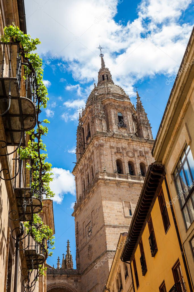 Bell tower of the historical Salamanca Cathedral seen from the Calderon de la Barca street