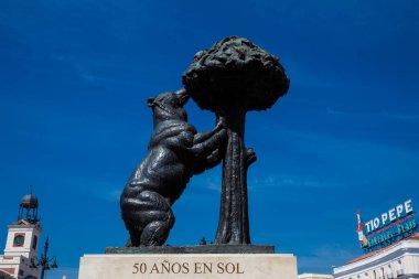 MADRID, SPAIN - MAY, 2018: The Statue of the Bear and the Strawberry Tree which represents the coat of arms of Madrid and is located on the east side of the Puerta del Sol square