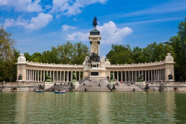 MADRID, SPAIN - MAY, 2018: Tourists and locals enjoying a beautiful spring day sailing at the Retiro Park pond