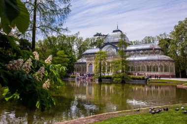 MADRID, SPAIN - MAY, 2018: View of the beautiful Palacio de Cristal a conservatory located in El Retiro Park built in 1887 in Madrid