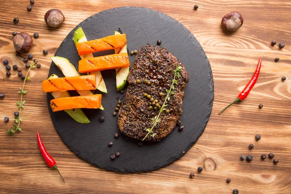 Жареный кусок мяса с жареными овощами — стоковое фото