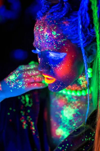 Luminous portrait of a girl in the UV rays on white background — Stock Photo, Image