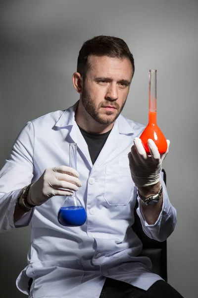 scientist compares the liquid in the laboratory