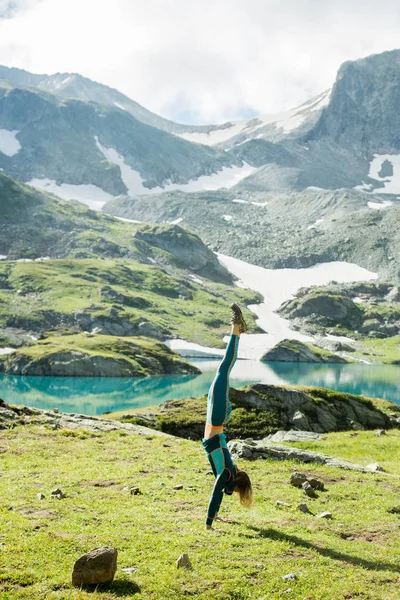 beautiful girl doing yoga in the mountains