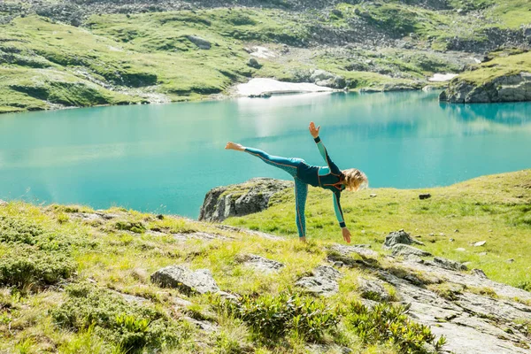 beautiful girl doing yoga in the mountains