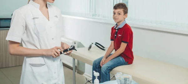 doctor takes a test from the boy to detect the covid-19 virus