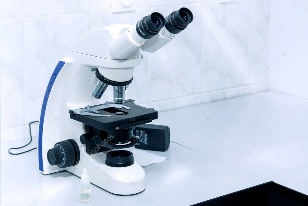 search for a covid-19 vaccine. studying tests under a microscope. scientific discovery