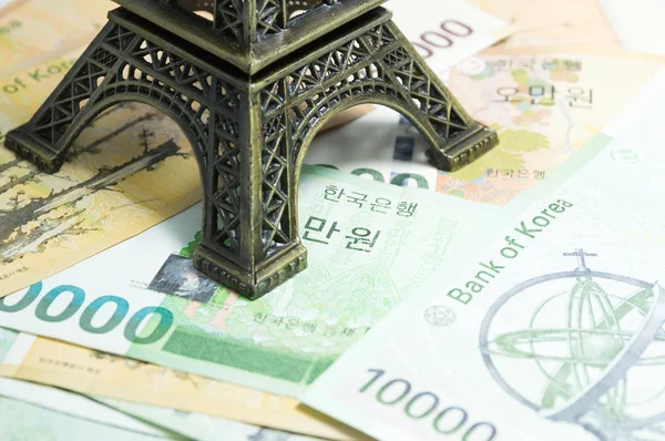 Korean money - money, finances and travel concept with Eiffel tower replica