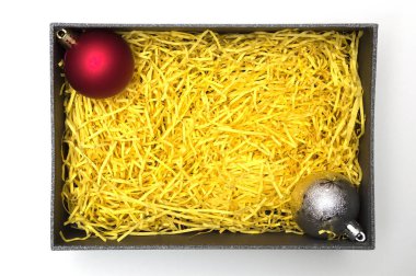 Topu siyah hediye kutusunda sarı ambalaj malzemesi ile