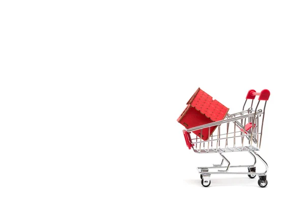 Miniature house and shopping cart on white background : economy — Stock Photo, Image