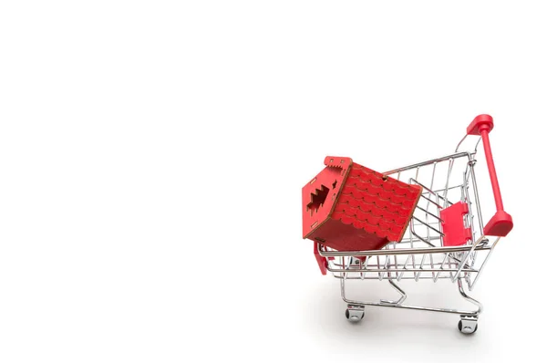 Miniature house and shopping cart on white background : economy — Stock Photo, Image